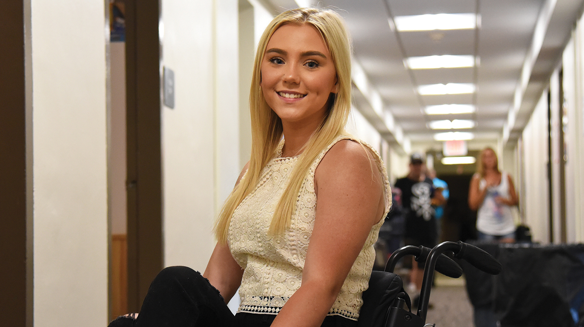 student in wheelchair on campus