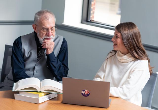 Professor McCown and female student at table learning