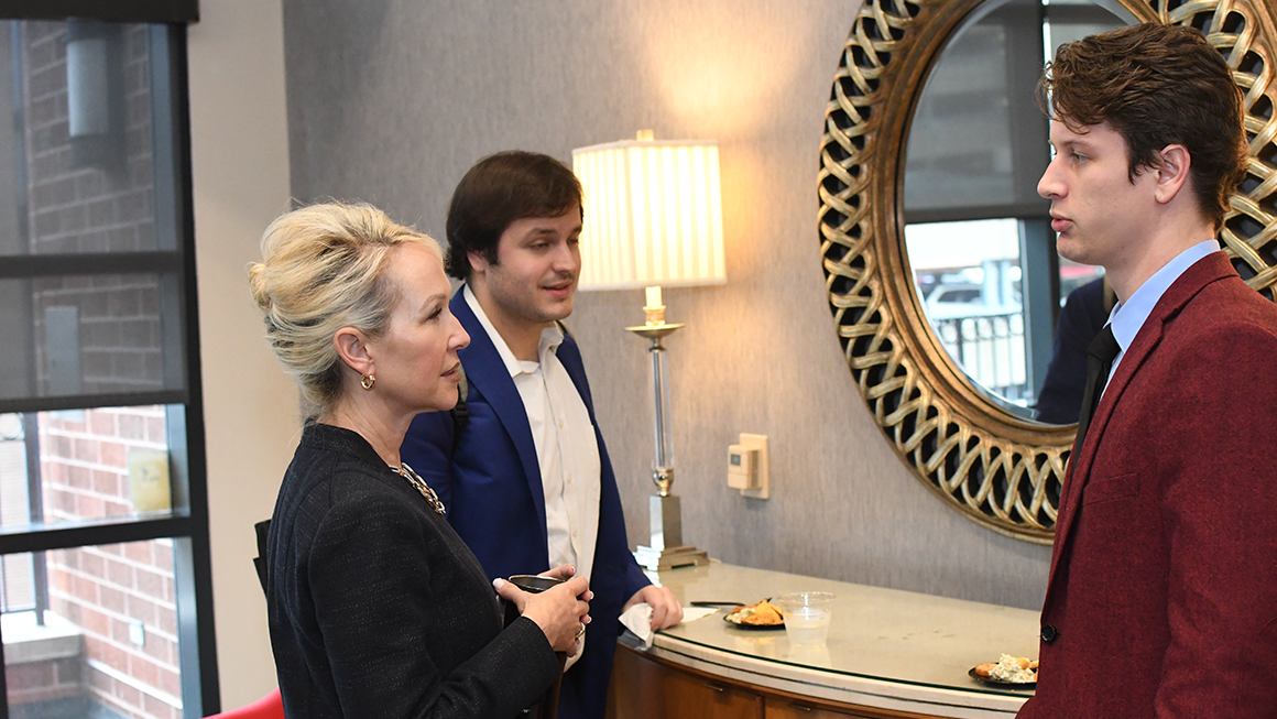 Law Dean April Barton talking with students at the reception following the Civil Discourse 2023 event