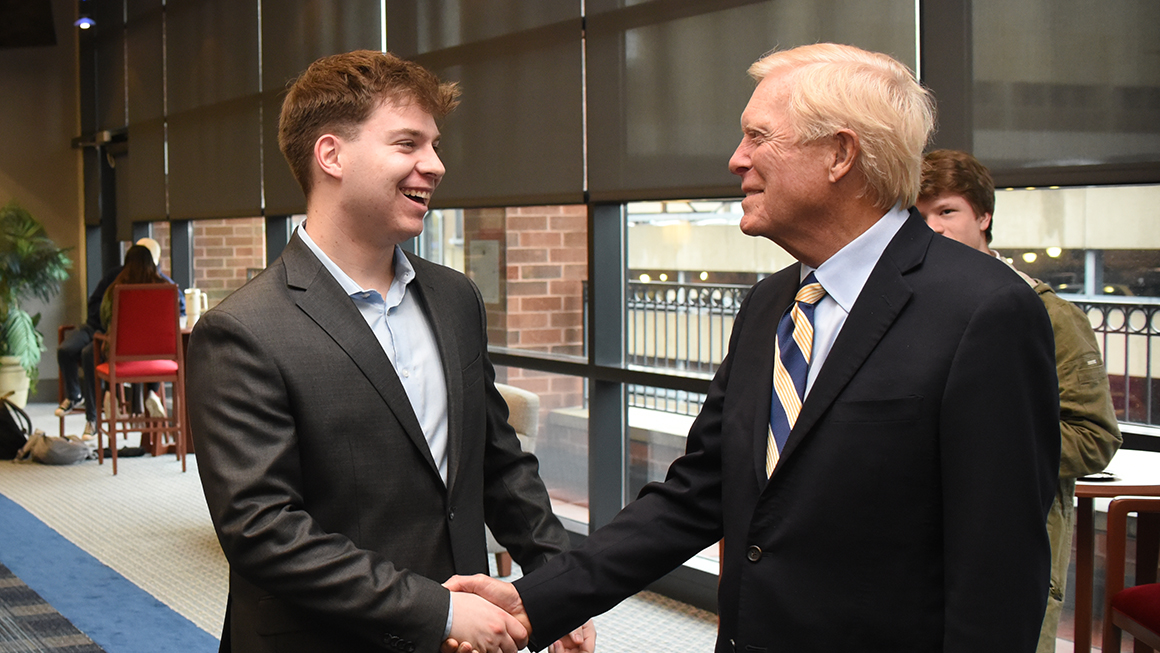 A Duquesne student shakes hands with Hon. Richard Gephardt at the Civil Discourse 2023 event reception.