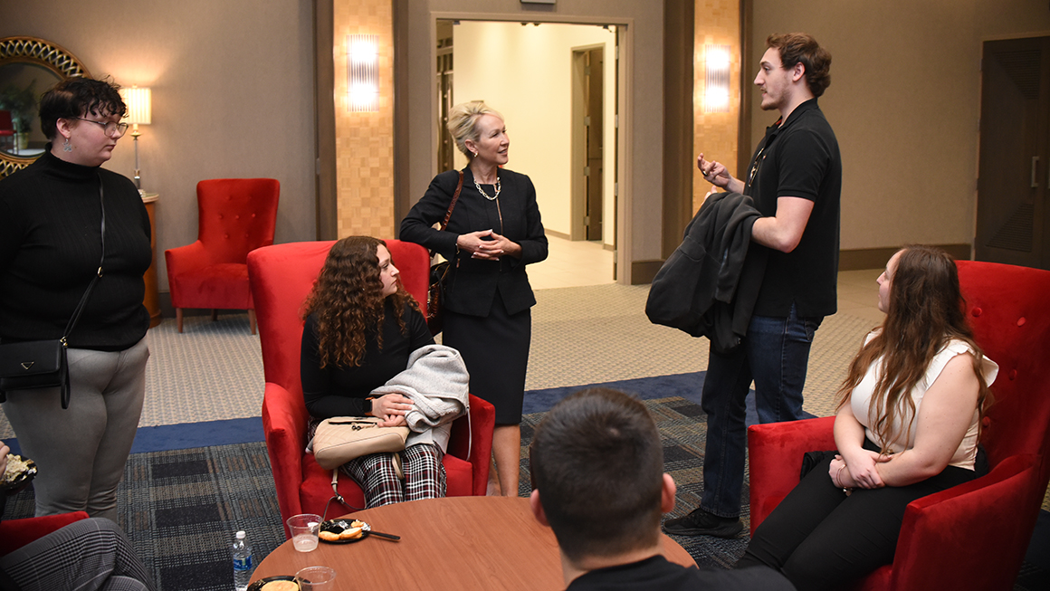 Law Dean April Barton talking with students at the reception following the Civil Discourse 2023 event