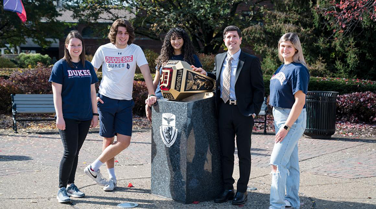 David standing with students by the Duquesne ring.