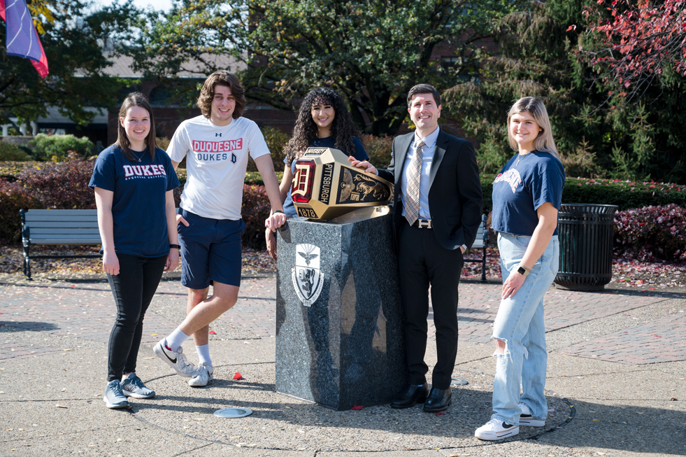 David Dausey at Ring Statue with four students