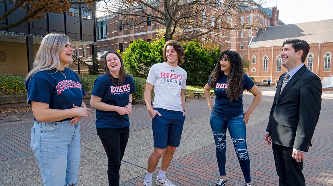 David Dausey laughing with Duquesne students on A-Walk