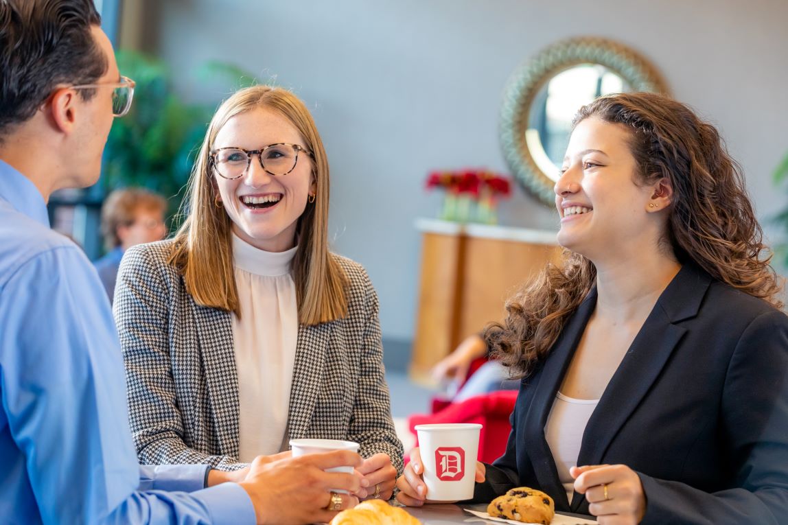 students around table laughing