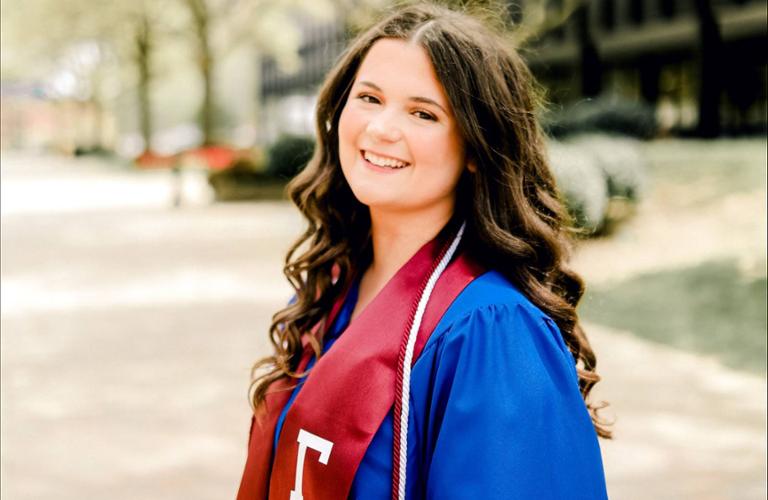 Photo of Kaylee Russman '22 in commencement regalia.