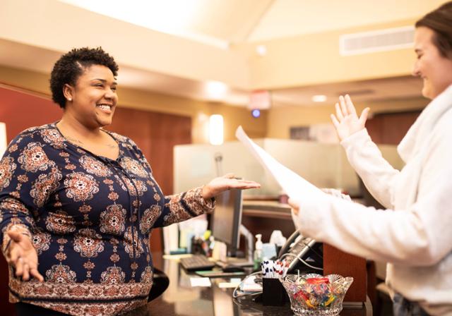 Two students talking at the Center for Career Development welcome desk.