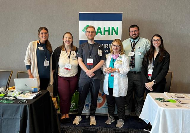 AHN Pharmacy staff and recruiters standing in front of table at Pharmacy Connect event