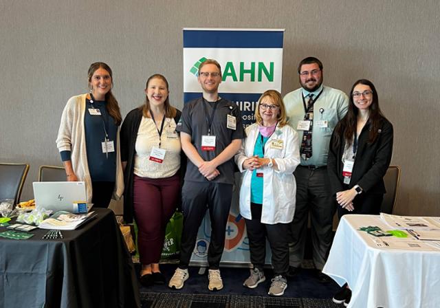 Group of Pharmacy Employers standing near their tables at the Pharmacy Connect event