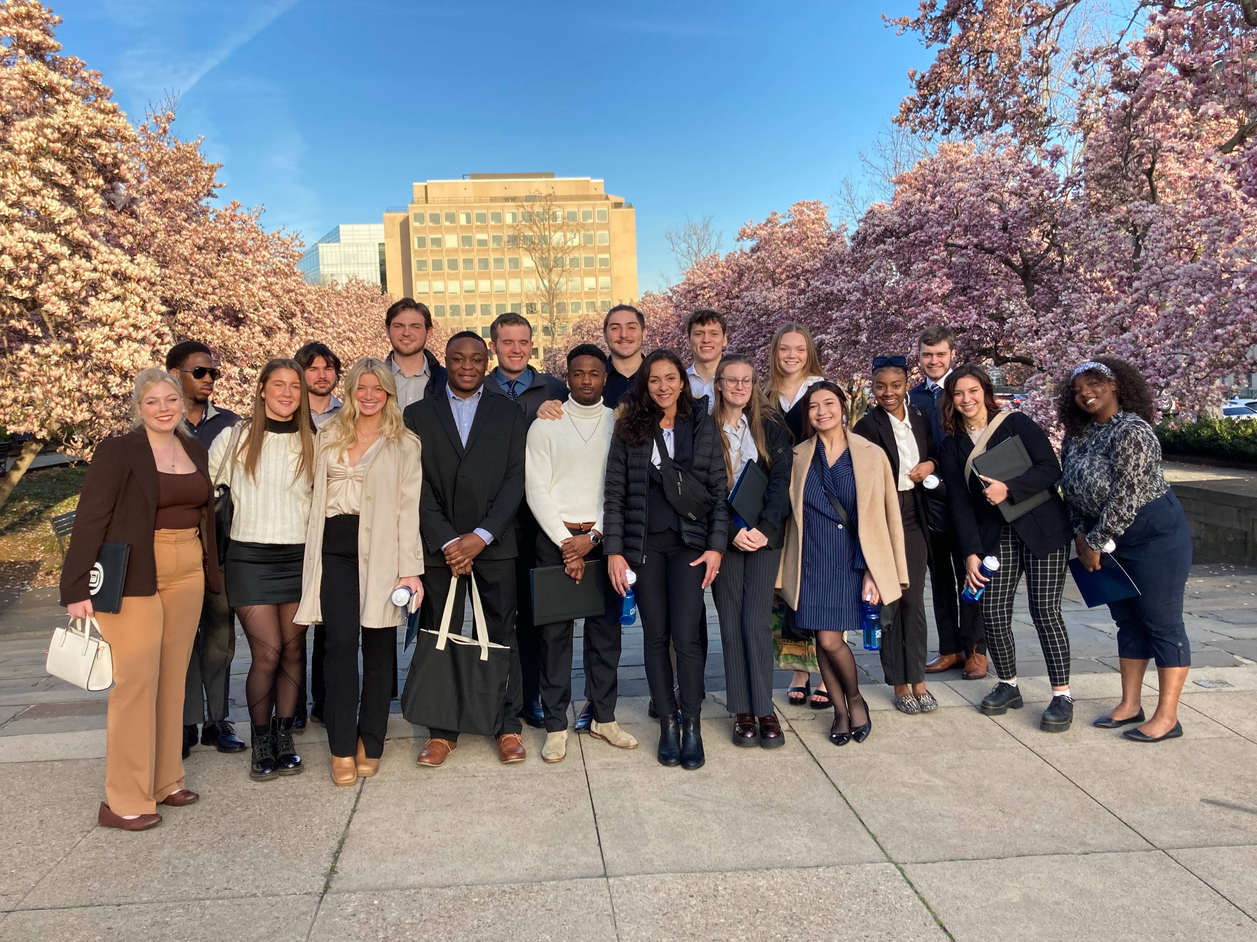 Alumni and students posing on the streets of Washington D.C., during a Career Road Trip
