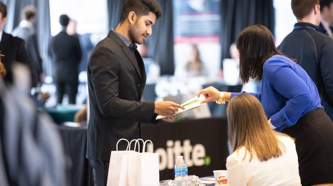 Student and employer talking during career fair