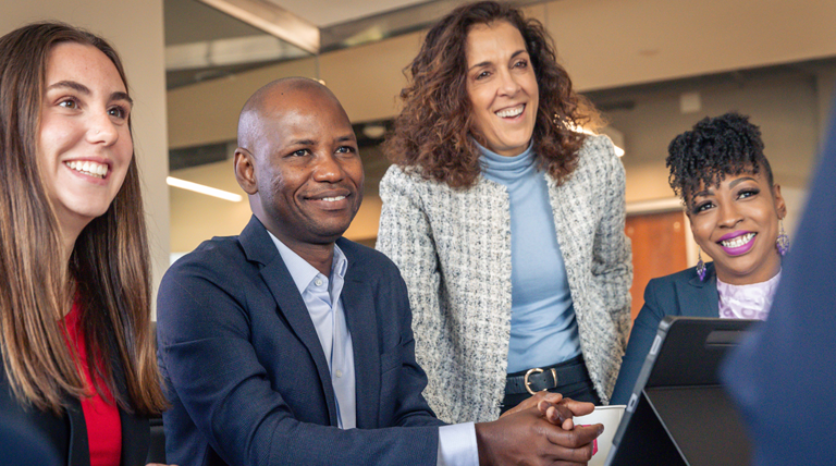 Three smiling students with Dr. Karen Donovan.