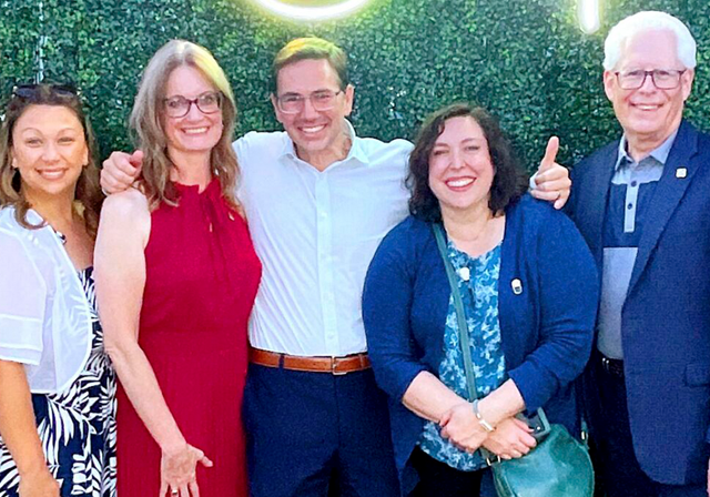 Duquesne faculty and staff celebrate HARP's fundraiser with Dean McFarlin.