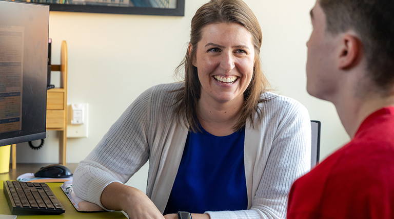 Smiling Success Coach Helping a Student