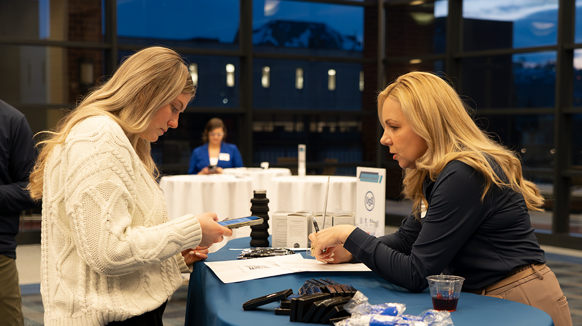 Student networking with industry partner