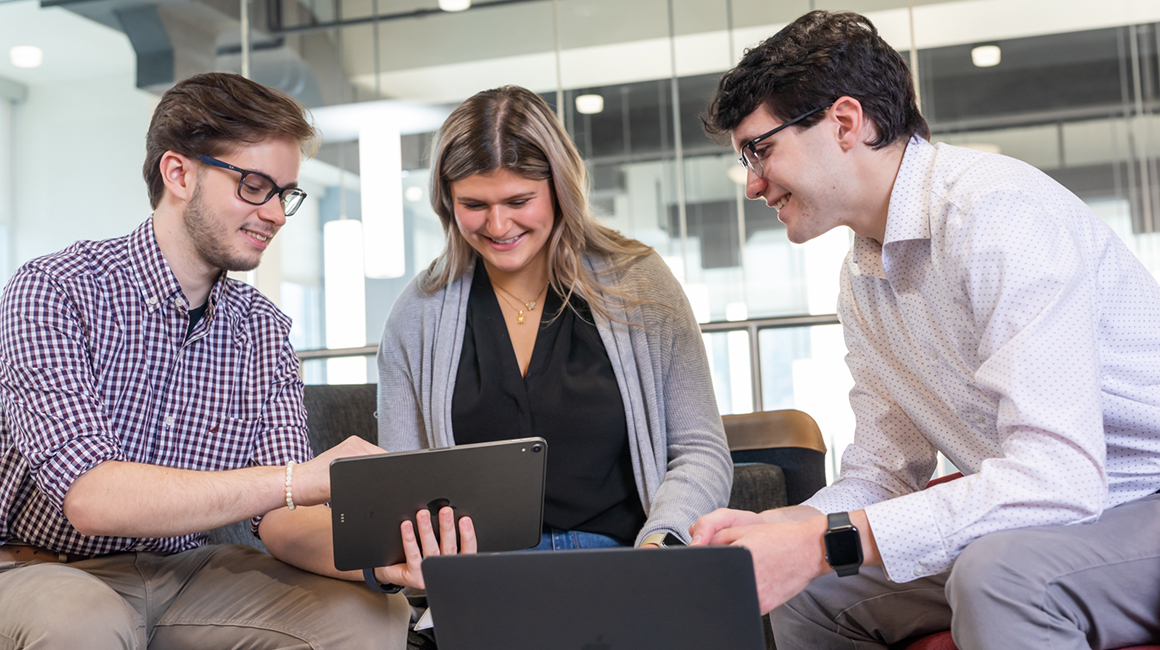 Three students work together in the center for student success. 