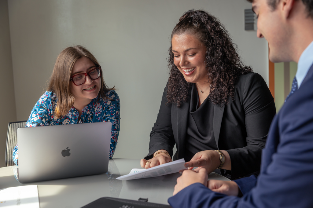 Two professionals review a document.