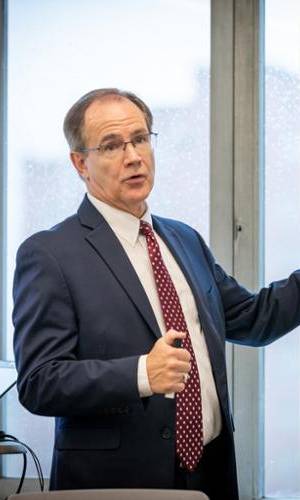 Dr. Philip Baird at a whiteboard.