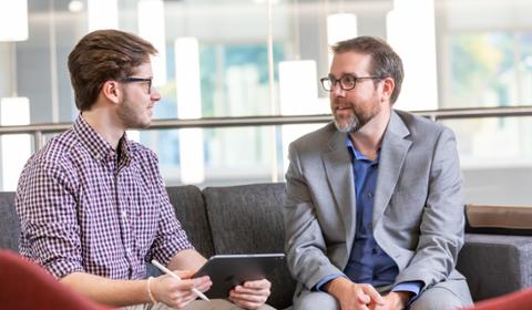 A student success coach talks with a student in the center for student success. 