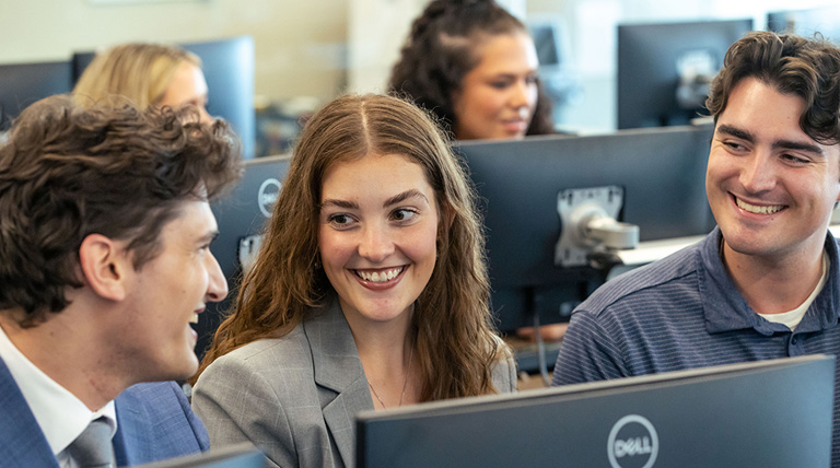 Three business students at a computer