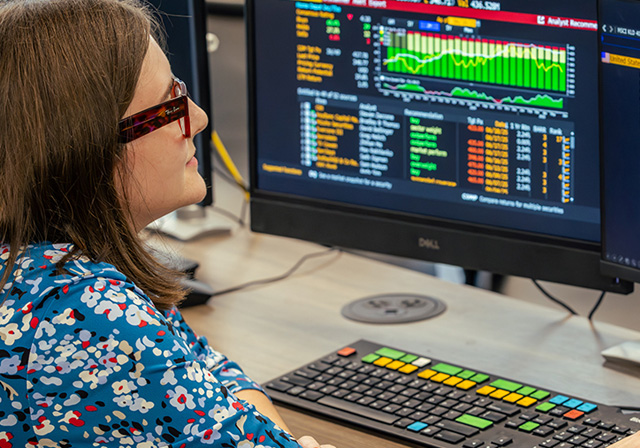 Business student using a Bloomberg terminal.