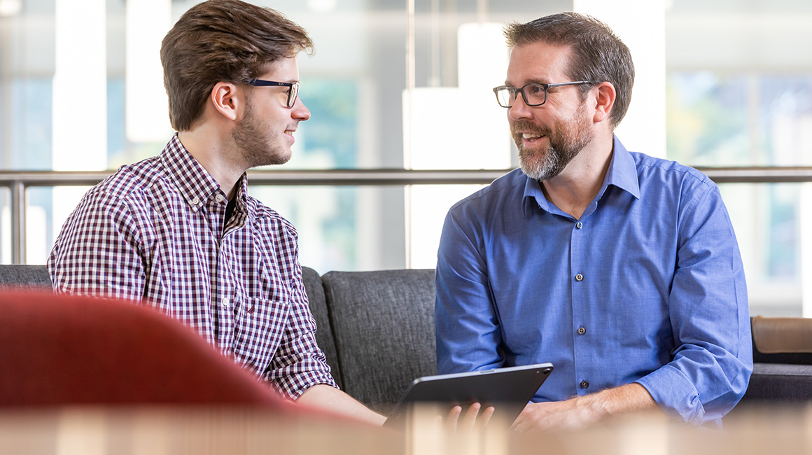 A business student talks with a student success coach in the Eugene P. Beard Center for Student Success.