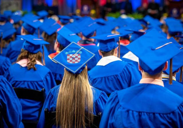 students at a commencement ceremony in regalia 