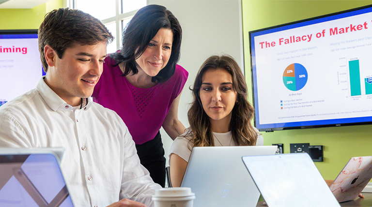 Business Analytics Co-Major (STEM) students work with a professor in class.