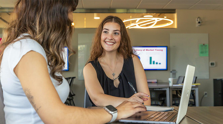 Two students collaborate in a classroom.