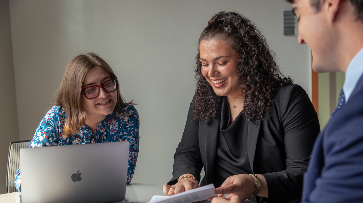 Professionals review financial documents.