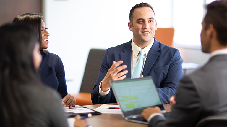 Accounting student meeting at a conference table. 
