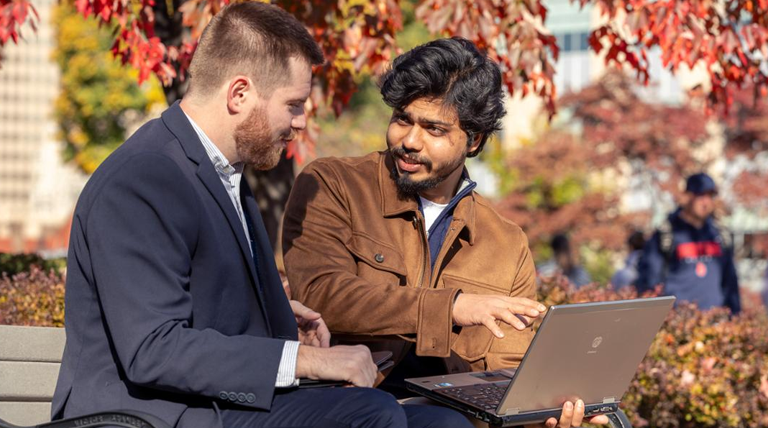 Two MSAIM graduate students meeting on Duquesne's campus.