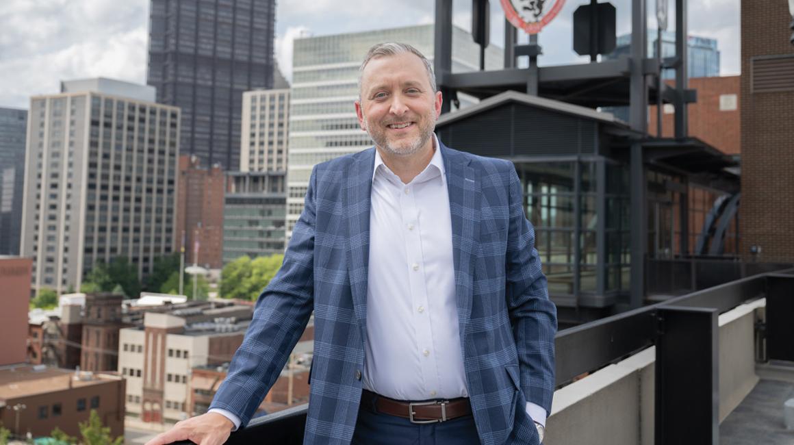 Kevin Lewis posing on Duquesne's campus