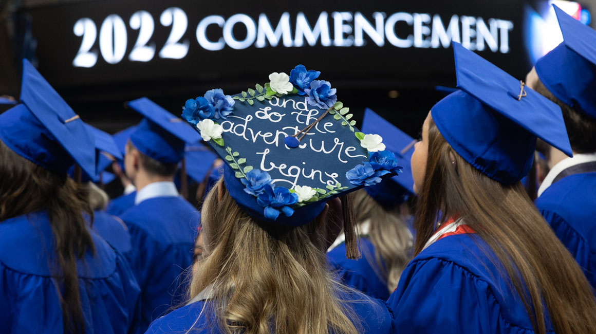 Students and their graduation caps from behind. 