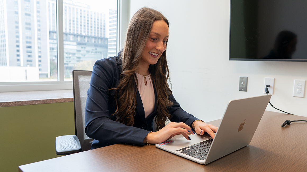 A student performs a sales role play in a simulation lab.