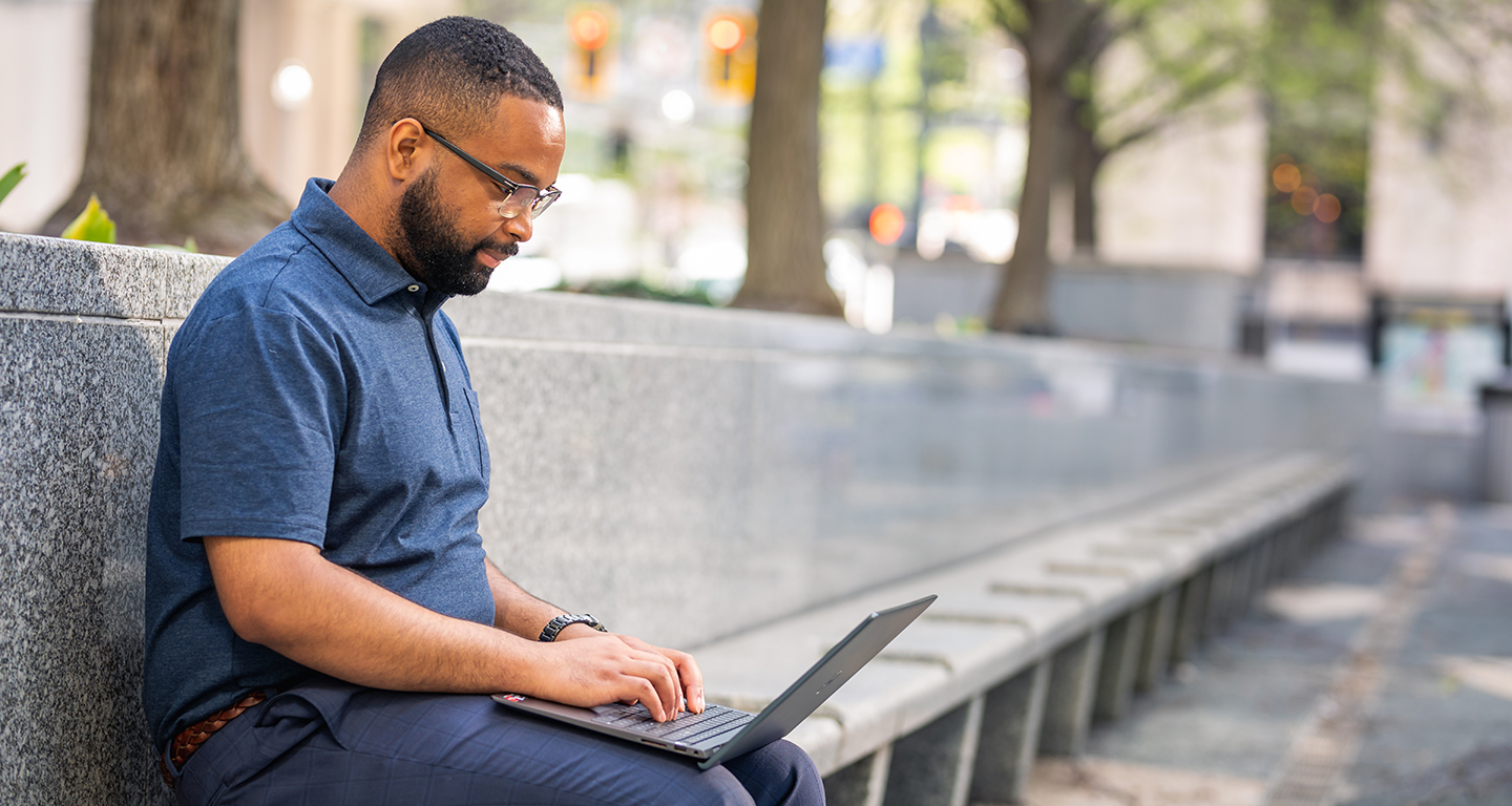 A business student studies outside. 