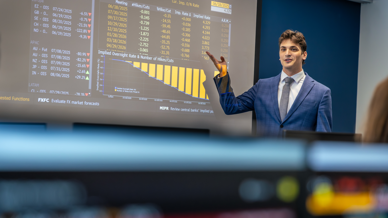A graduate student presents financial data to his peers.