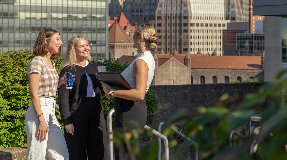 Gen Z business professional chat outside.