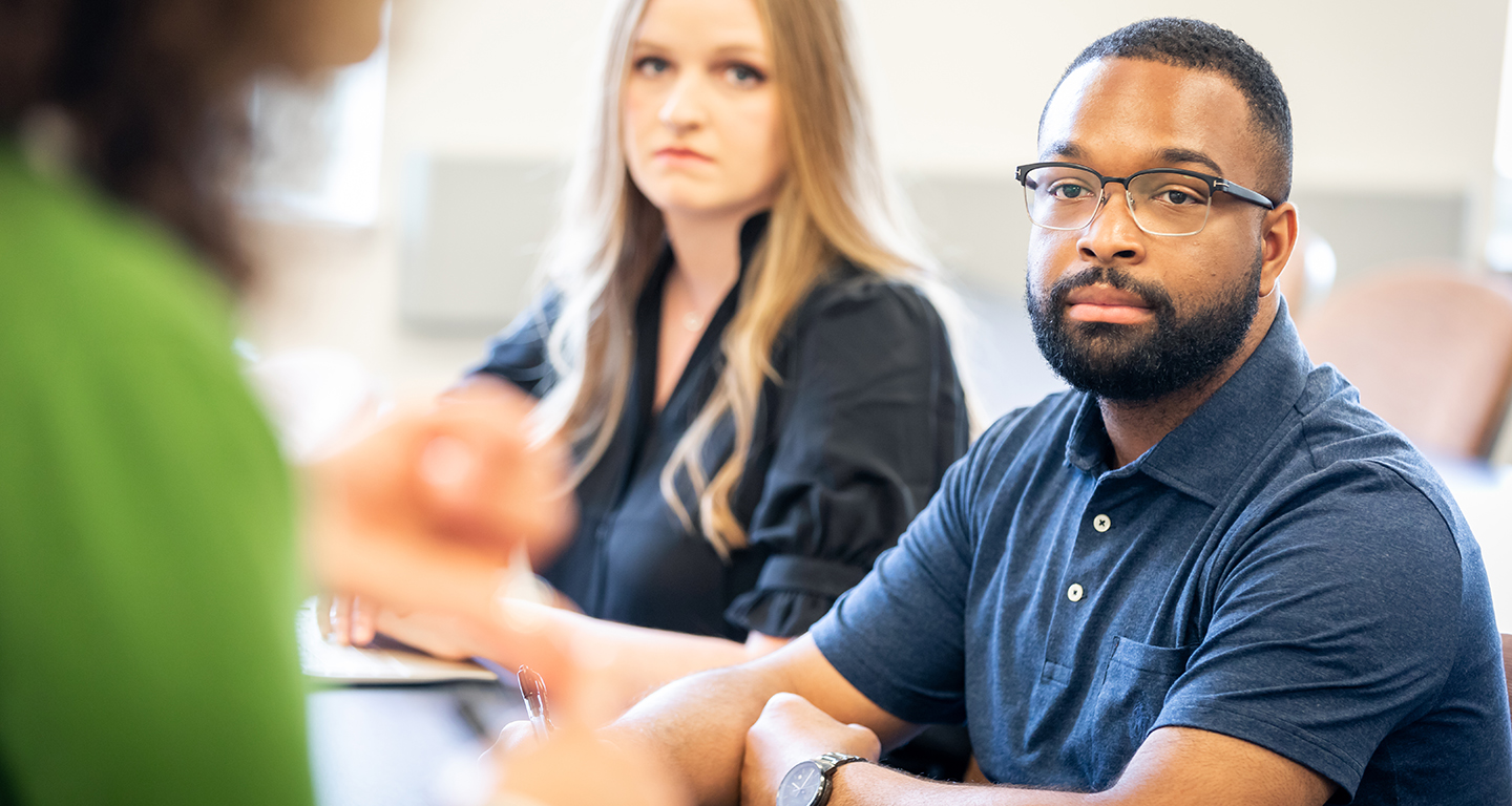 Business students listen in class. 