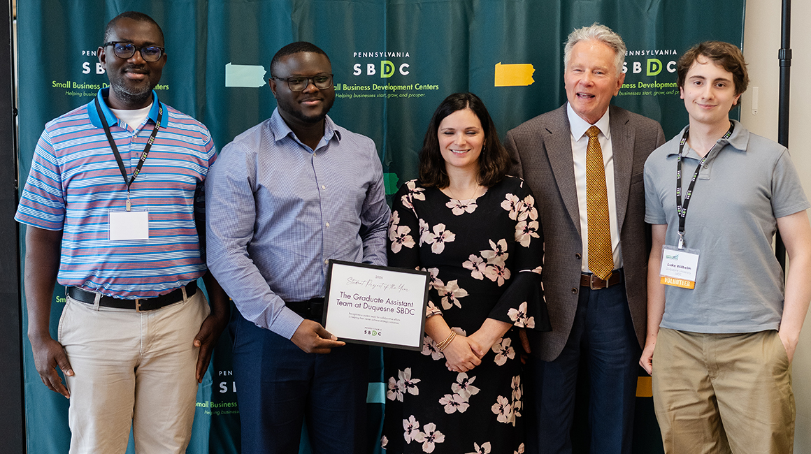 The SBDC's Graduate Assistant Team with the Student Project of the Year Award.