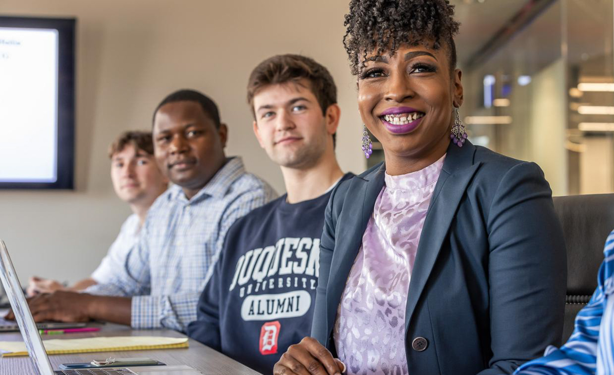 Duquesne University business students looking forward and smiling
