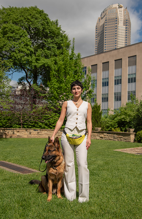 Rosie poses outside with a German Shepherd. 