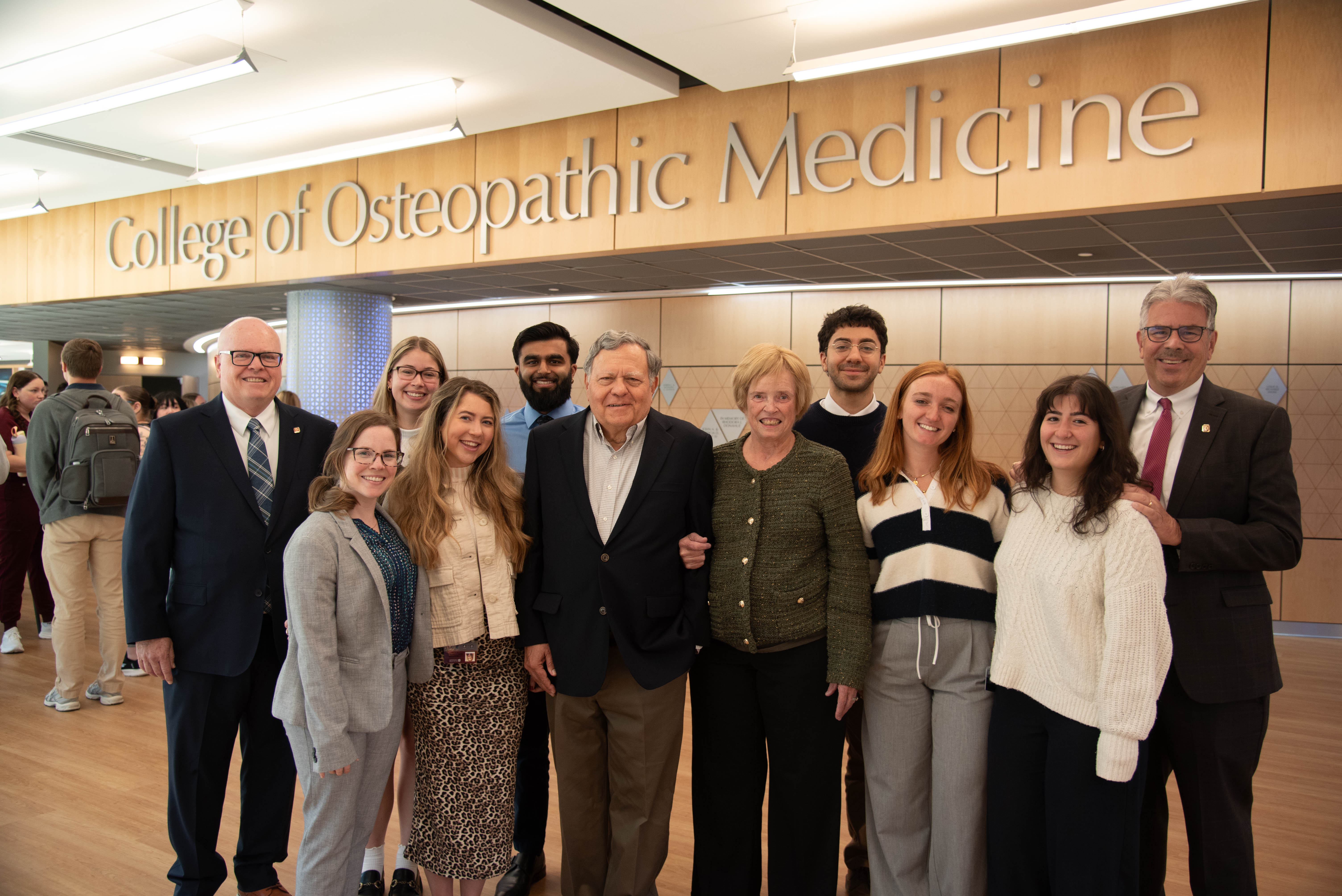 The Nasutis and others pose for a photo inside the College of Medicine.