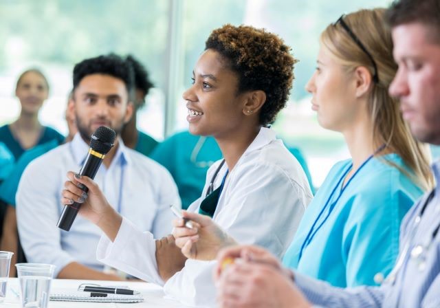 health professionals talking at conference