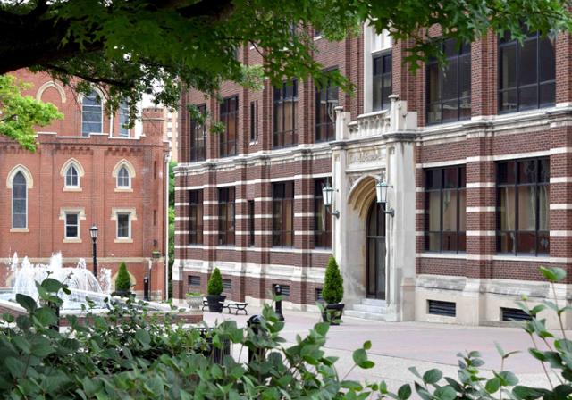 Tree framed Canevin Hall along Academic Walk with Administration Building in background