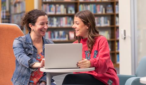 Duquesne student and faculty member working together on a laptop