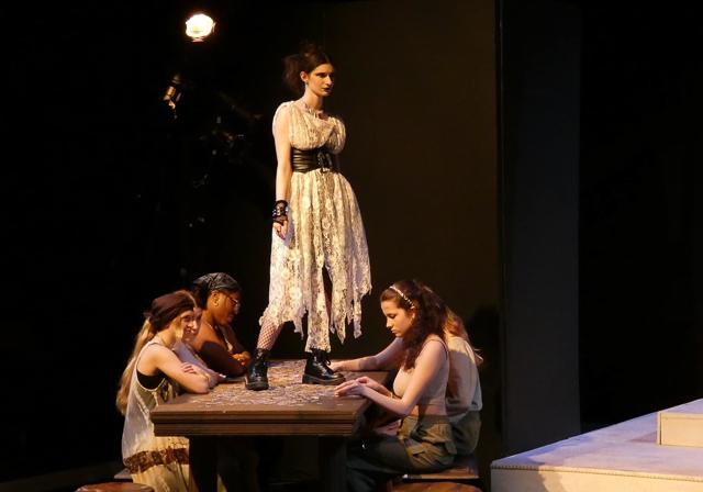 Duquesne student Susie Betten on Red Masquers stage in table scene from Medea