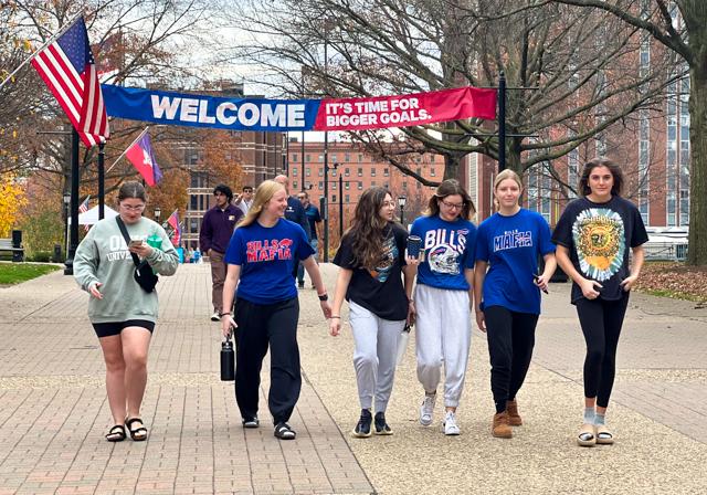Image of students walking under welcome banner on Academic Walk