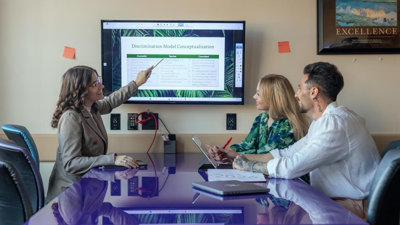 Graduate students engaging in classroom lesson in CACREP-accredited School M.S.Ed. School Counseling program discussing strategies.