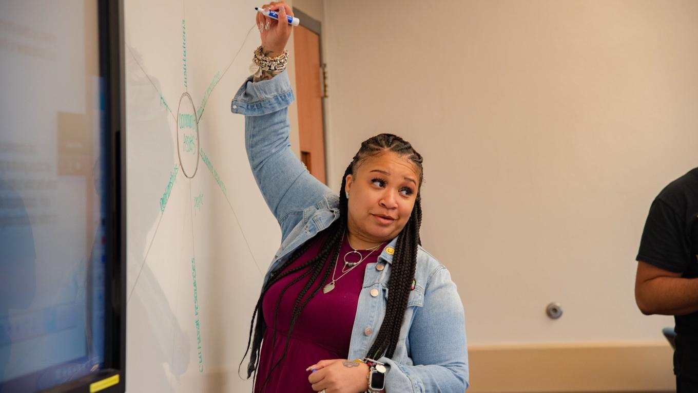 Image of School Supervision Certification student writing on board in a school setting